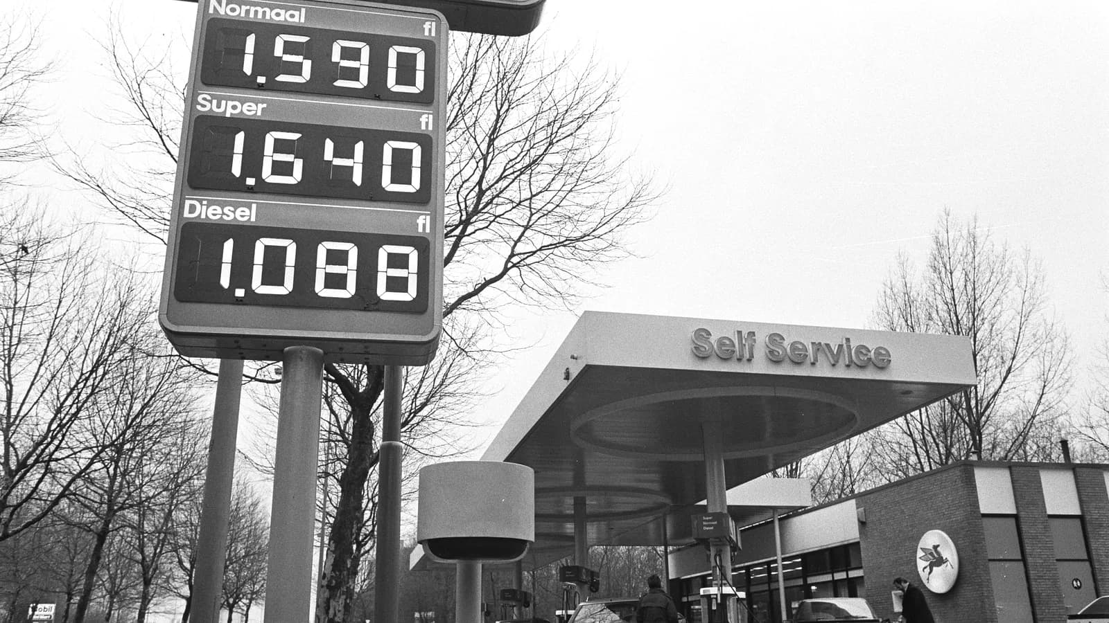 Un cartel de estación de servicio con los precios de cada combustible en números grandes, leíbles desde la calle